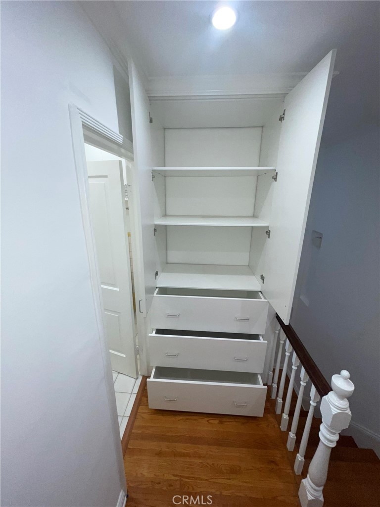 135 Canon Drive Beverly Hills, CA 90212 - Photo 19 of 42 a view of walk in closet with empty racks