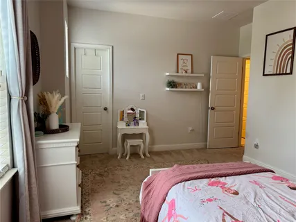 a bedroom with a bed and a chair