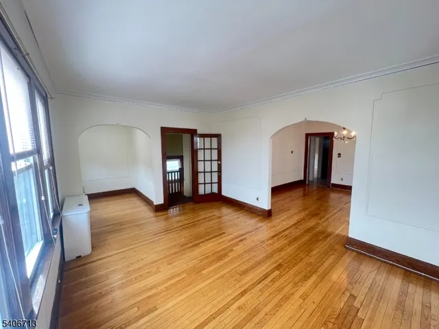 an empty room with wooden floor and a window