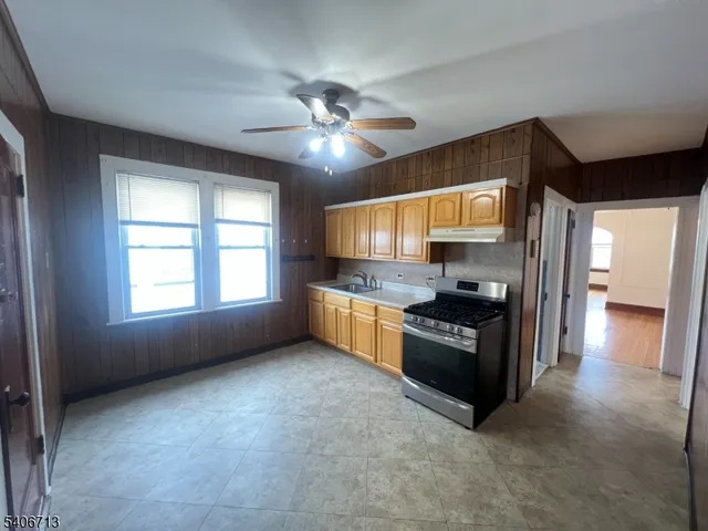 a kitchen with stainless steel appliances granite countertop a stove and a refrigerator