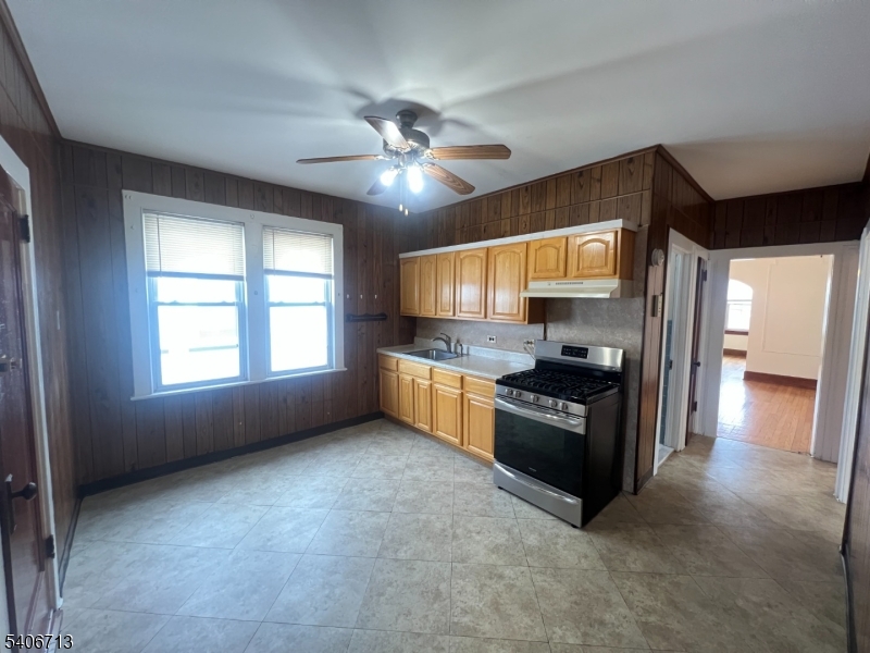 1044 Cross Avenue Elizabeth, NJ 07208 - Photo 3 of 9 a kitchen with stainless steel appliances granite countertop a stove and a refrigerator