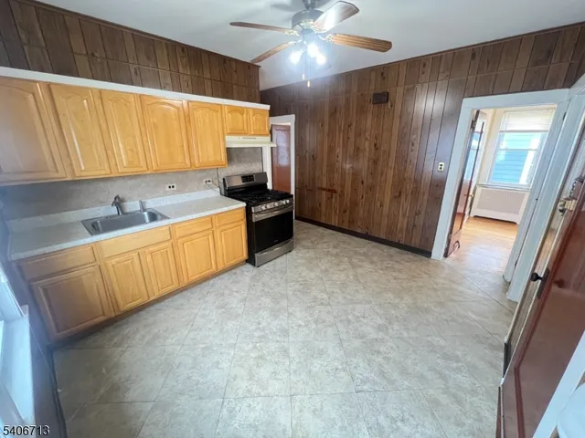 a large kitchen with a sink and cabinets