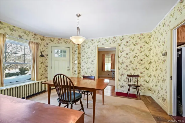a view of a livingroom with furniture window and wooden floor