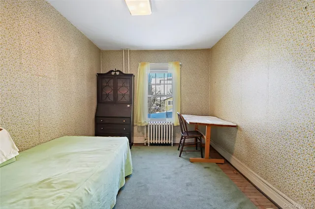 a bedroom with a bed and a desk