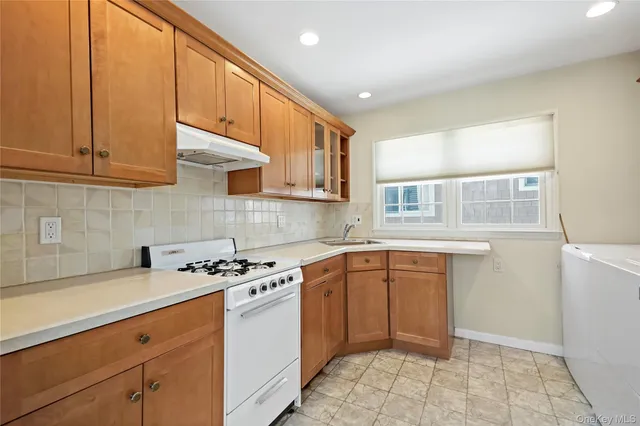 a kitchen with stainless steel appliances granite countertop a sink stove and cabinets
