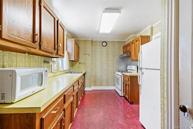 a kitchen with a sink stove and a refrigerator