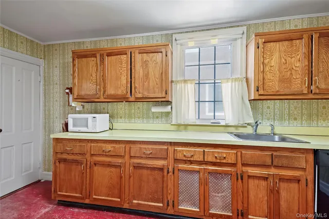 a kitchen with granite countertop cabinets and window