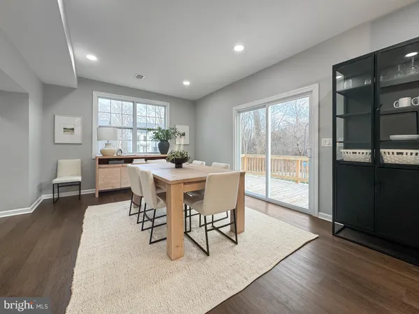 a dining room with furniture and wooden floor