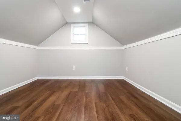 a view of a big room with wooden floor and windows in a room
