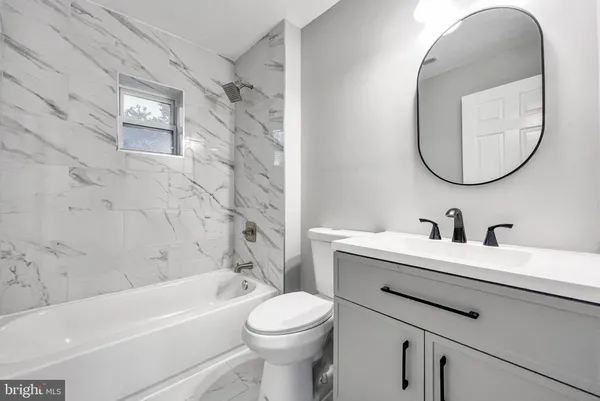 a bathroom with a sink toilet and a bathtub
