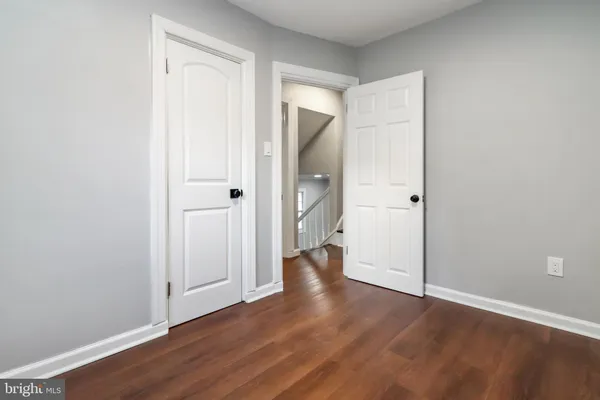 wooden floor with white walls