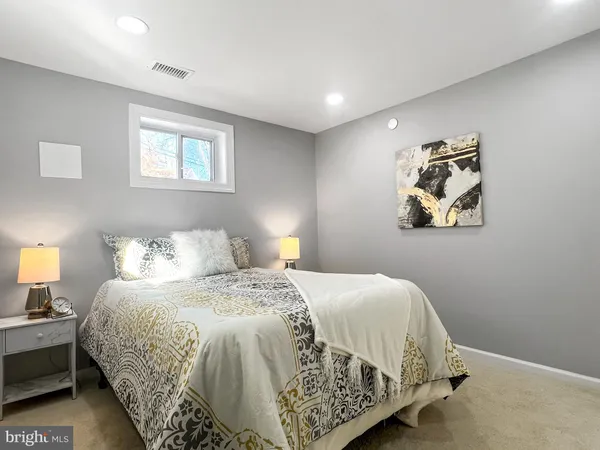 a bedroom with a bed and a lamp