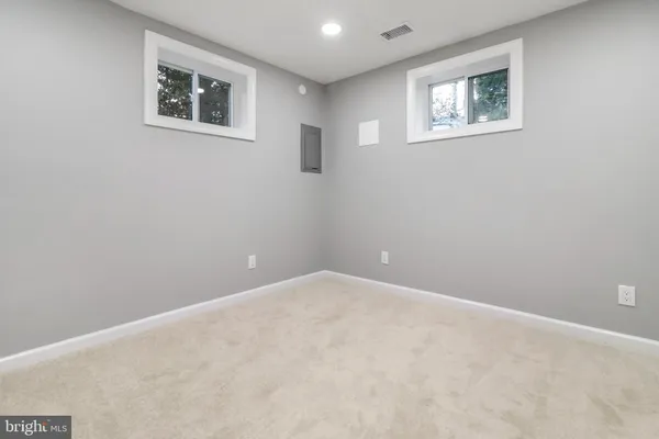 an empty room with a painting on the wall