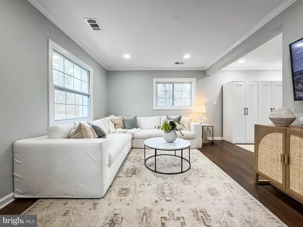 a living room with furniture a rug and a large window