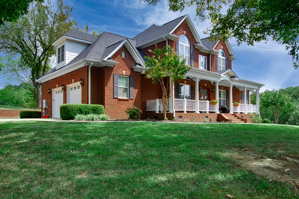 983 Veto Road Prospect, TN 38477 - Photo 2 of 43 front view of house with a yard and an trees