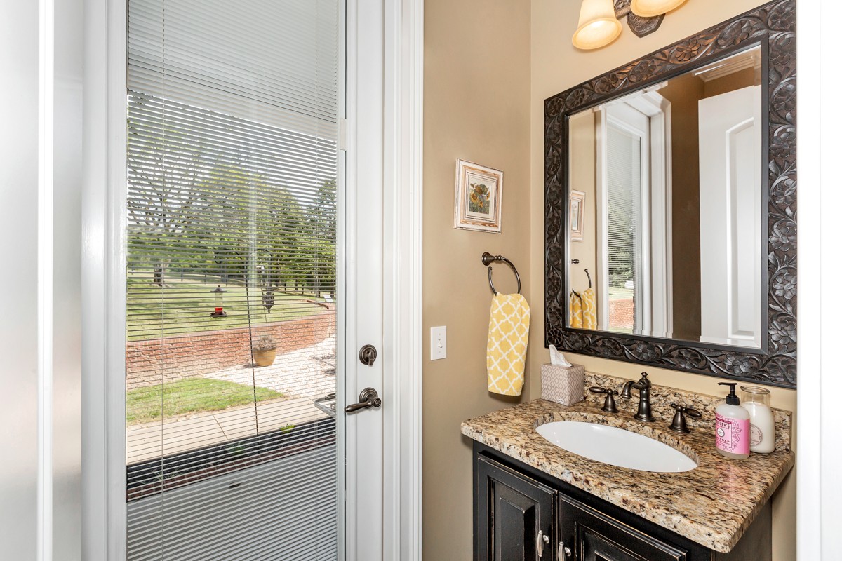 983 Veto Road Prospect, TN 38477 - Photo 15 of 43 a bathroom with a granite countertop sink and a mirror