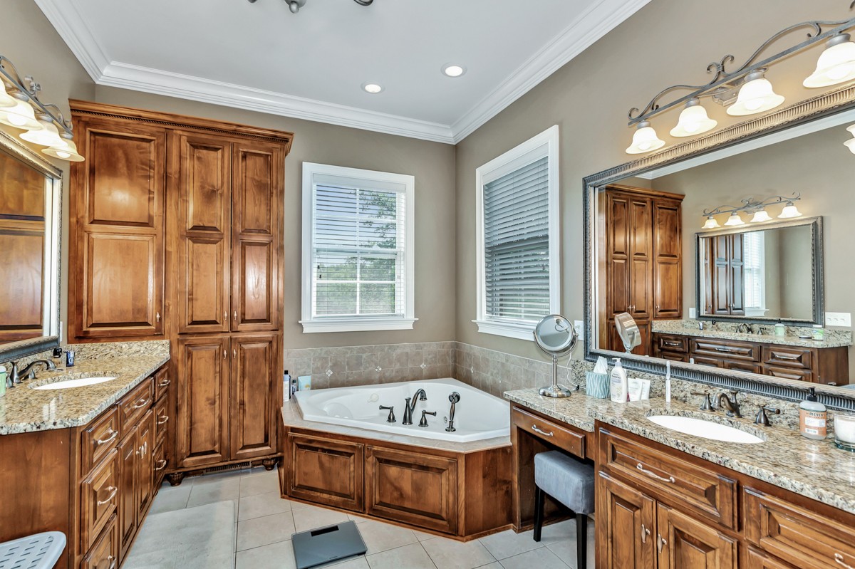 983 Veto Road Prospect, TN 38477 - Photo 17 of 43 a bathroom with a granite countertop tub sink and mirror