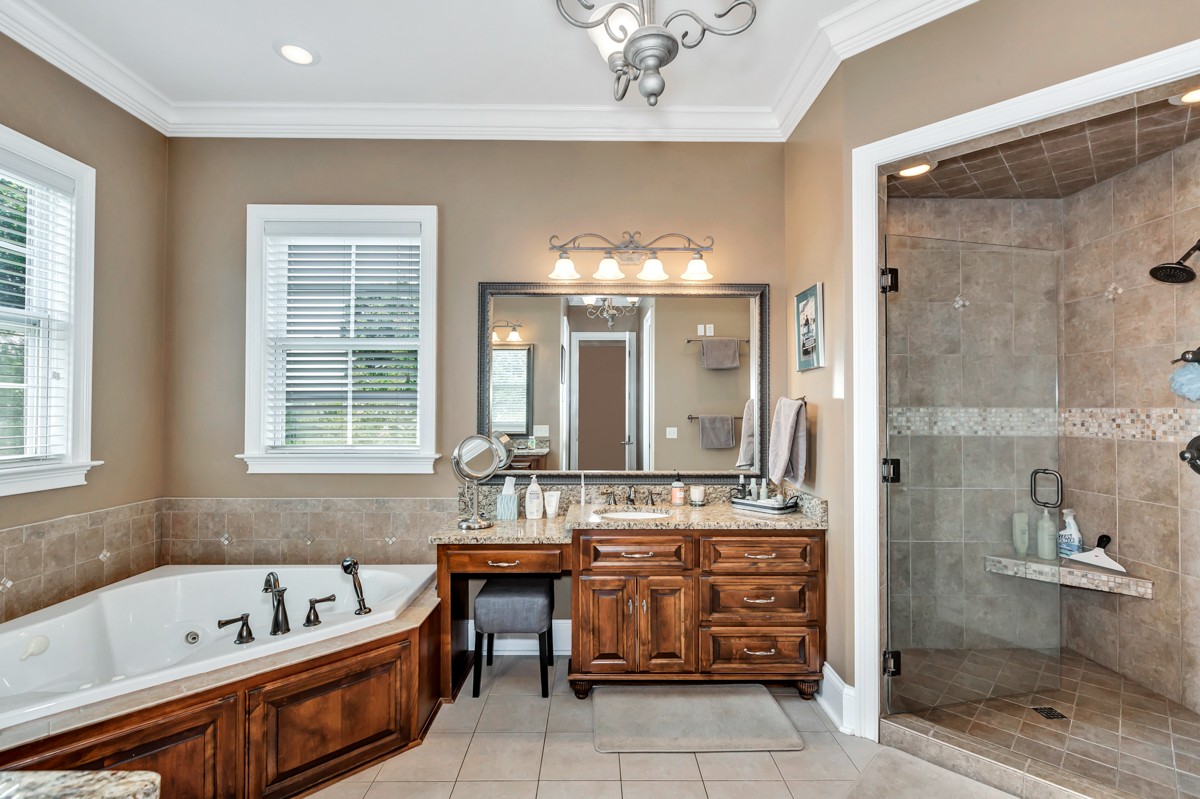 983 Veto Road Prospect, TN 38477 - Photo 18 of 43 a bathroom with a tub sink shower and mirror