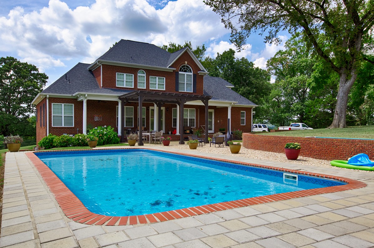 983 Veto Road Prospect, TN 38477 - Photo 32 of 43 a view of swimming pool with lawn chairs and plants