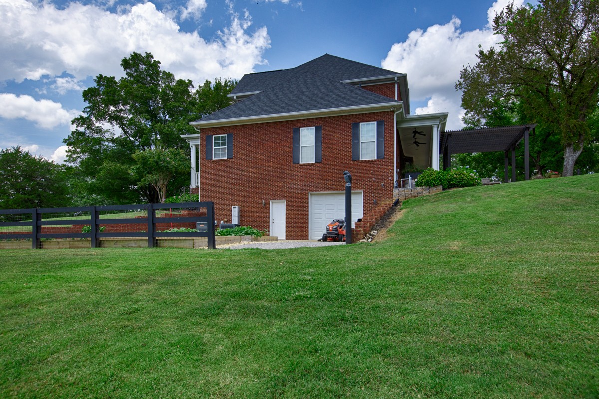 983 Veto Road Prospect, TN 38477 - Photo 34 of 43 a front view of a house with a yard