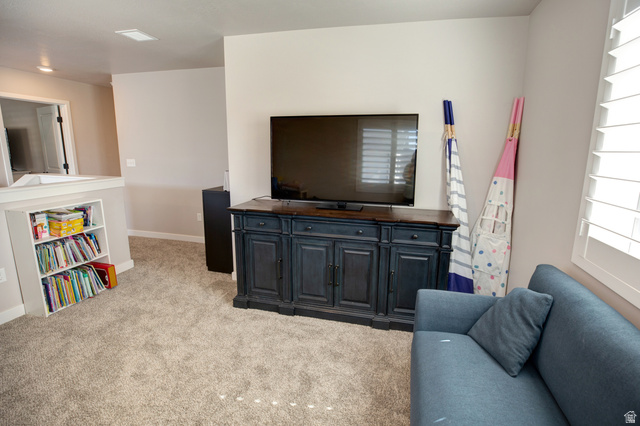 983 South 950 West Provo, UT 84601 - Photo 41 of 56 Carpeted interior space featuring a built-in bookshelf, neutral wall tones, and plantation shutters
