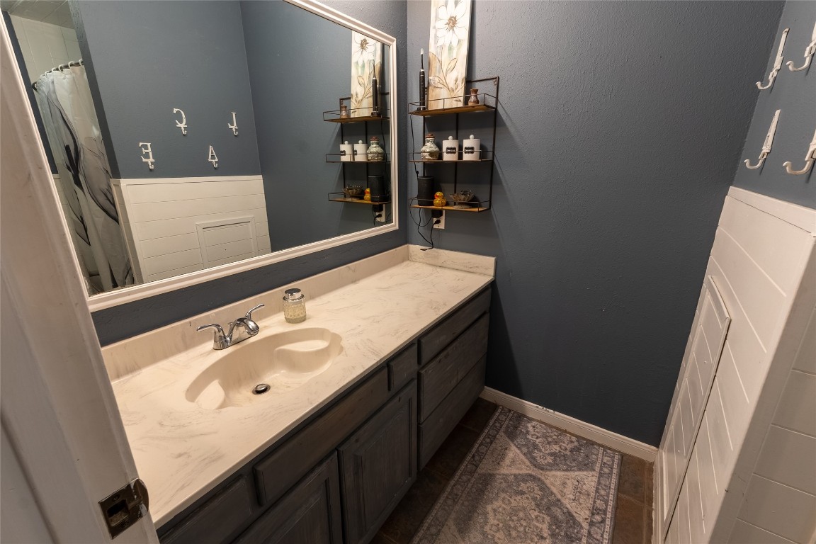 5818 Yorkgate Drive Spring, TX 77373 - Photo 12 of 19 Stylish bath with shiplap wainscoting and modern fixtures, offering both charm and functionality.