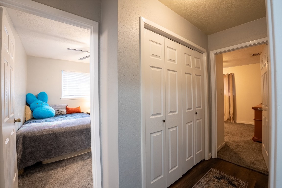 5818 Yorkgate Drive Spring, TX 77373 - Photo 13 of 19 Spacious hallway connecting bedrooms with ample closet storage — a functional layout perfect for family living.