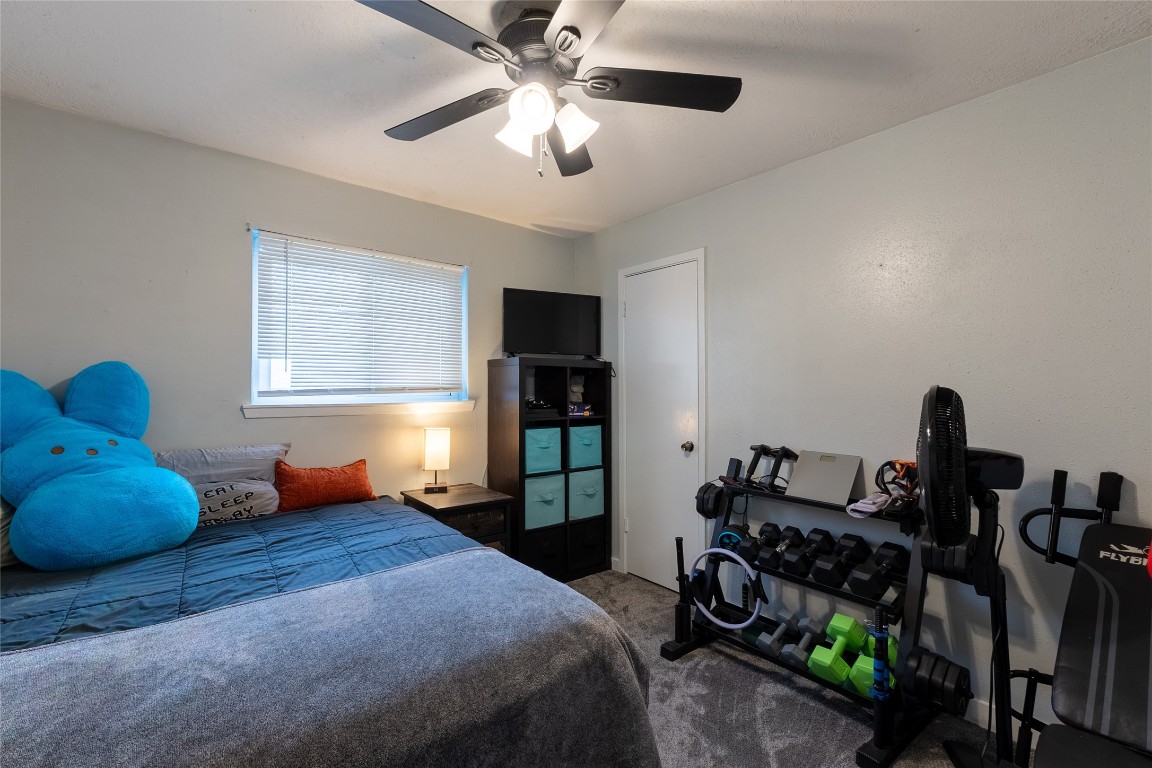 5818 Yorkgate Drive Spring, TX 77373 - Photo 15 of 19 Versatile guest bedroom or home gym with neutral tones, ceiling fan, and ample natural light.