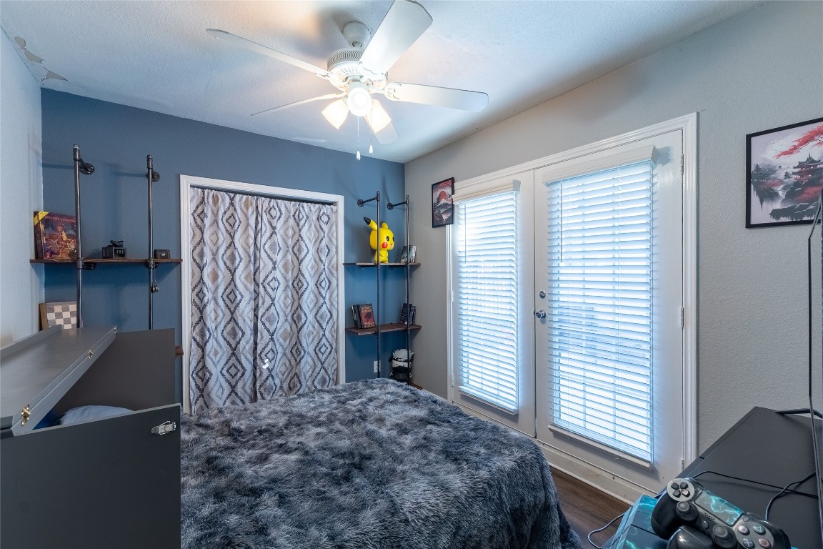 5818 Yorkgate Drive Spring, TX 77373 - Photo 16 of 19 Cozy bedroom with French doors leading outside and stylish shelving — ideal as a bedroom or office space.
