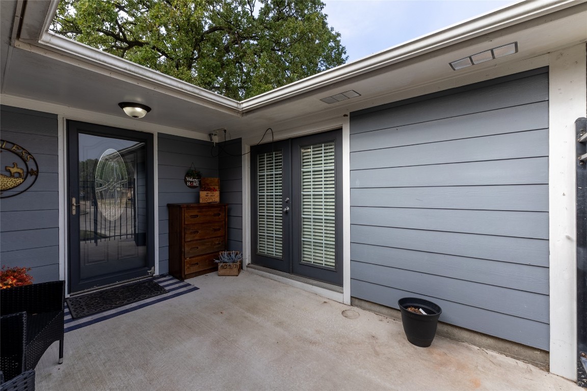 5818 Yorkgate Drive Spring, TX 77373 - Photo 2 of 19 Inviting front courtyard offers a private outdoor sitting area with French doors leading to the fourth bedroom or flex space.