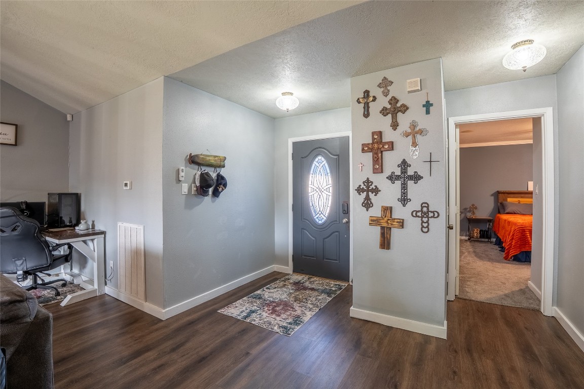 5818 Yorkgate Drive Spring, TX 77373 - Photo 3 of 19 Inviting entryway with wood-look flooring and decorative wall features, setting the tone for this welcoming home.