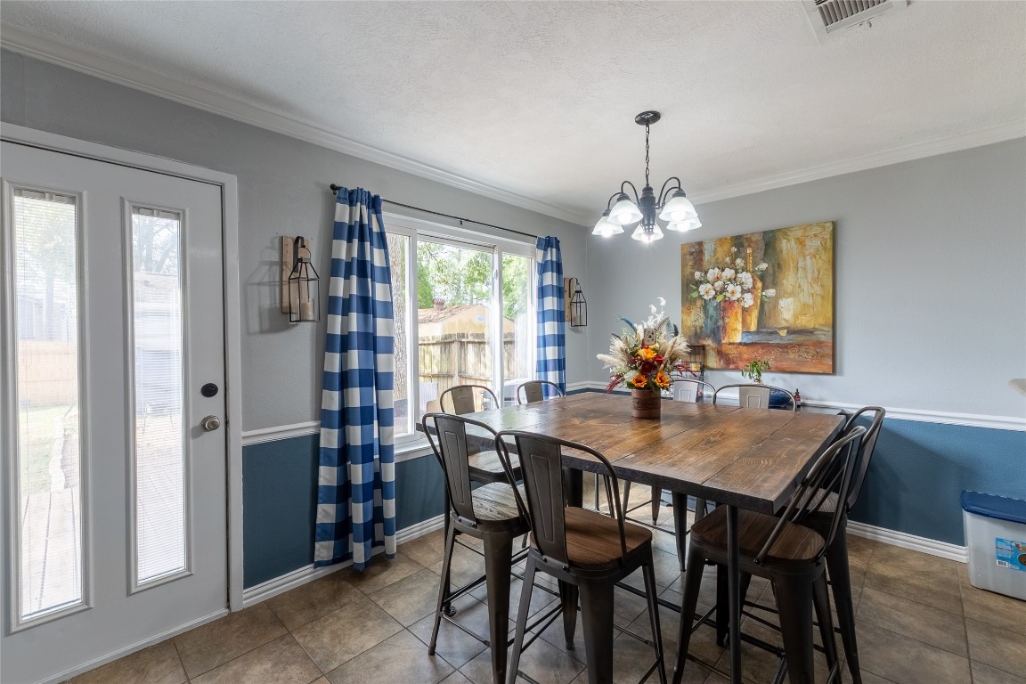 5818 Yorkgate Drive Spring, TX 77373 - Photo 5 of 19 Bright dining area with large windows, backyard views, and modern lighting — ideal for family meals or dinner parties.