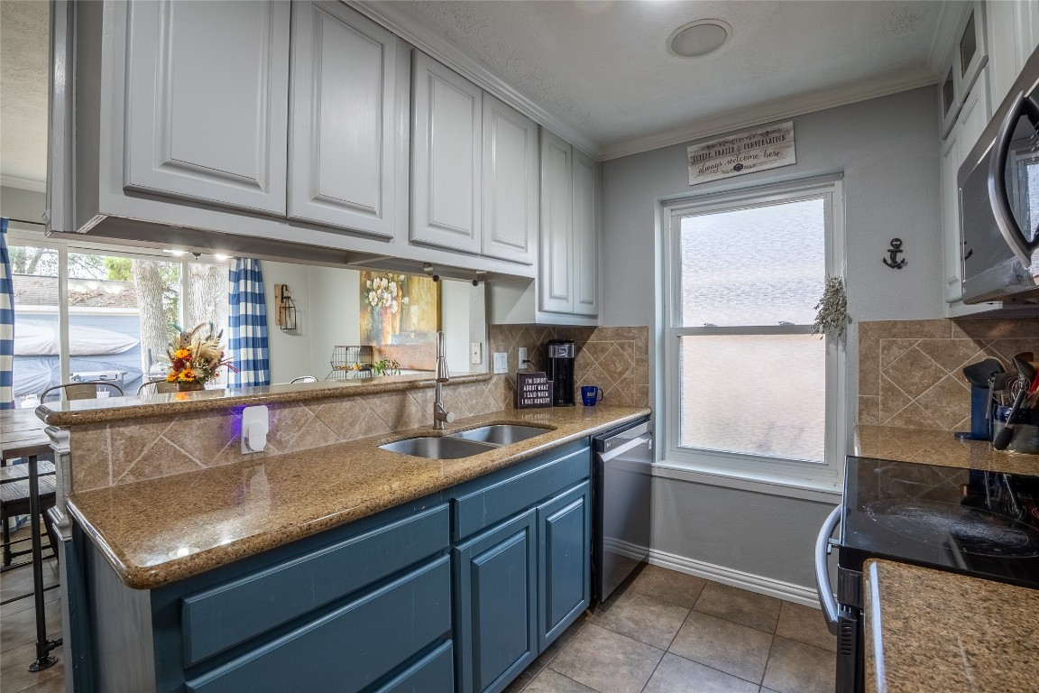 5818 Yorkgate Drive Spring, TX 77373 - Photo 6 of 19 Stylish kitchen with updated cabinetry, granite countertops, stainless steel appliances, and a convenient pass-through to the living room.