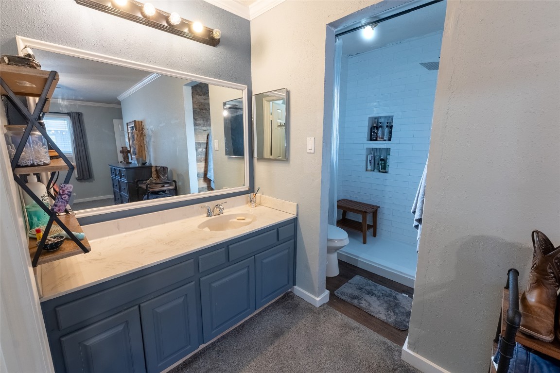 5818 Yorkgate Drive Spring, TX 77373 - Photo 10 of 19 Primary bath featuring a large vanity, updated fixtures, and a beautifully remodeled walk-in shower with built-in shelving.