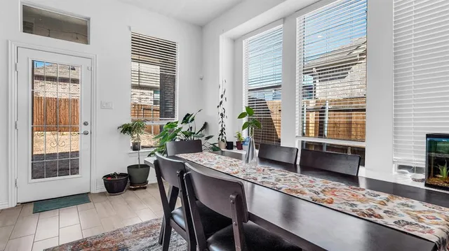 a dining room with furniture and windows