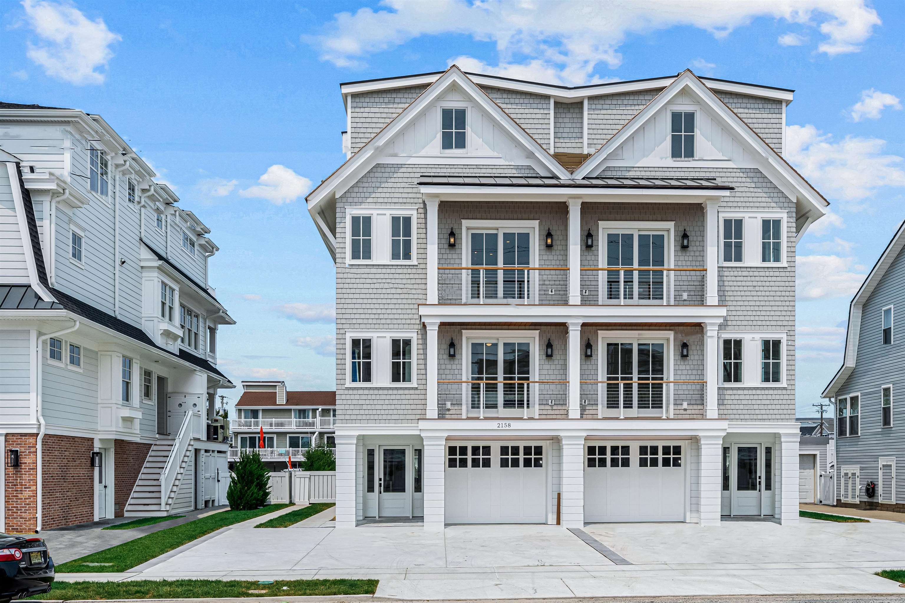 a front view of a residential apartment building with a yard