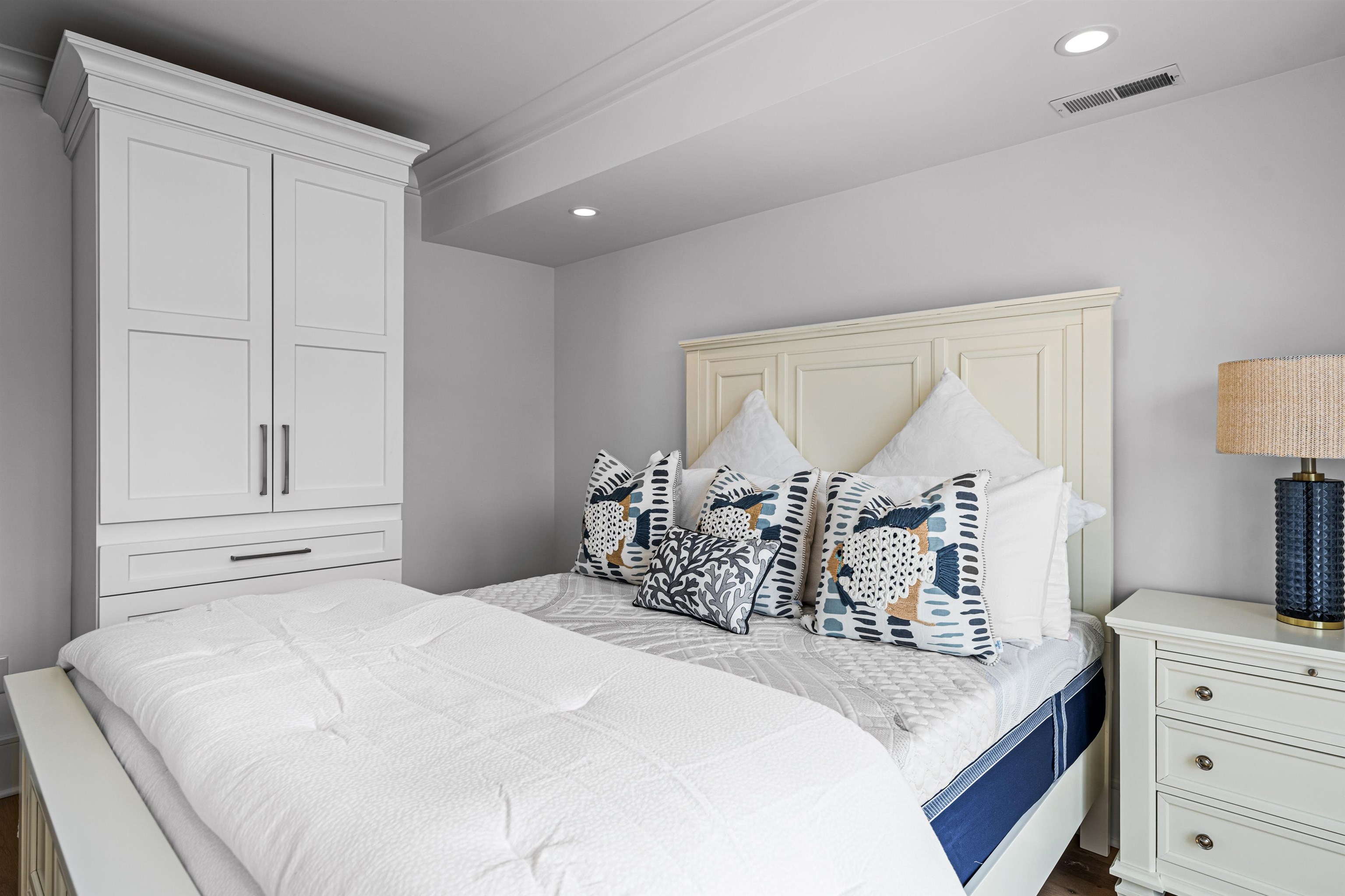 2158 Ocean Drive, Unit 2158 Avalon, NJ 08202 - Photo 11 of 50 a bedroom with a bed and dresser with mirror