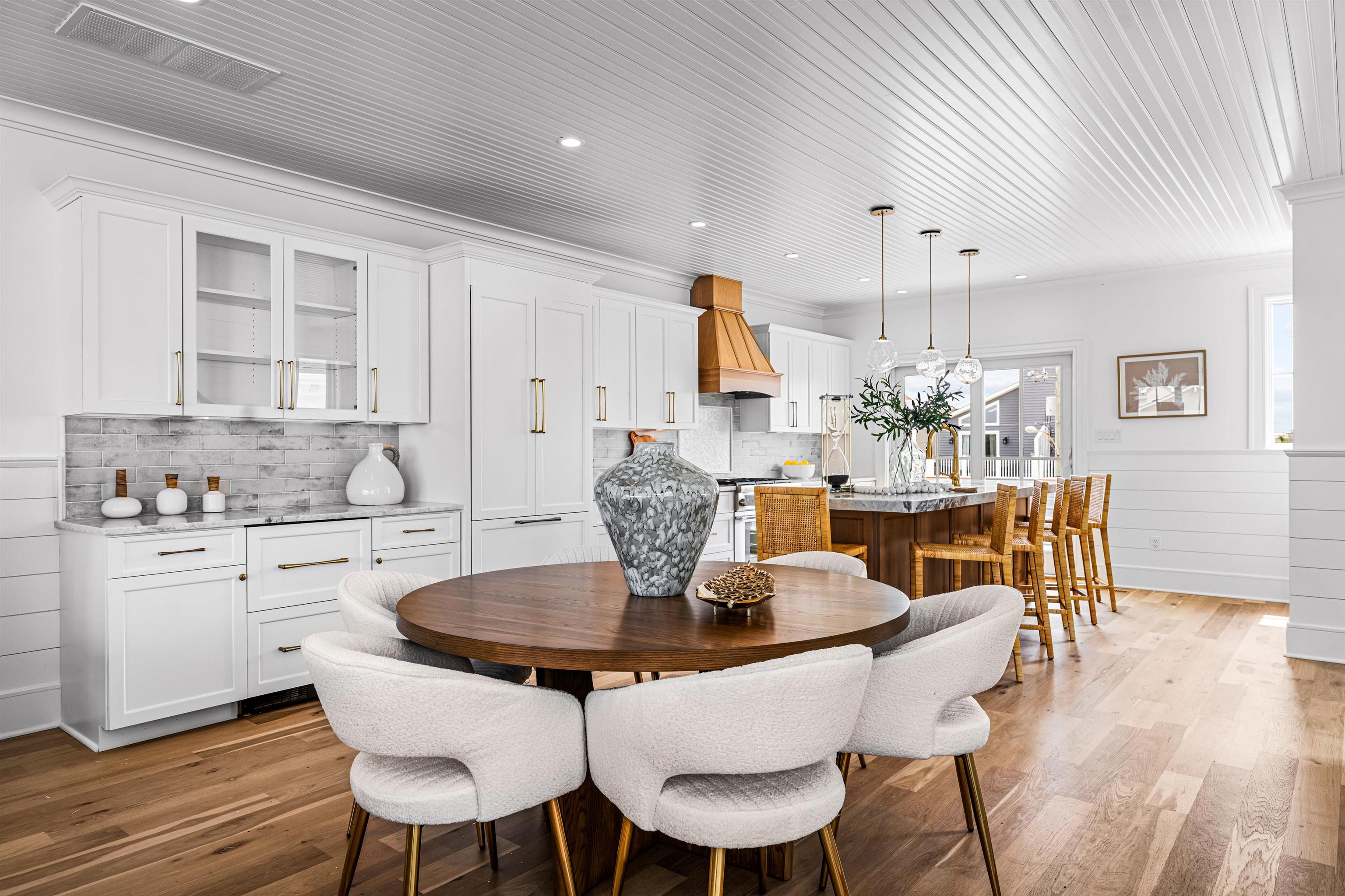 2158 Ocean Drive, Unit 2158 Avalon, NJ 08202 - Photo 17 of 50 a dining room with furniture a kitchen and chandelier