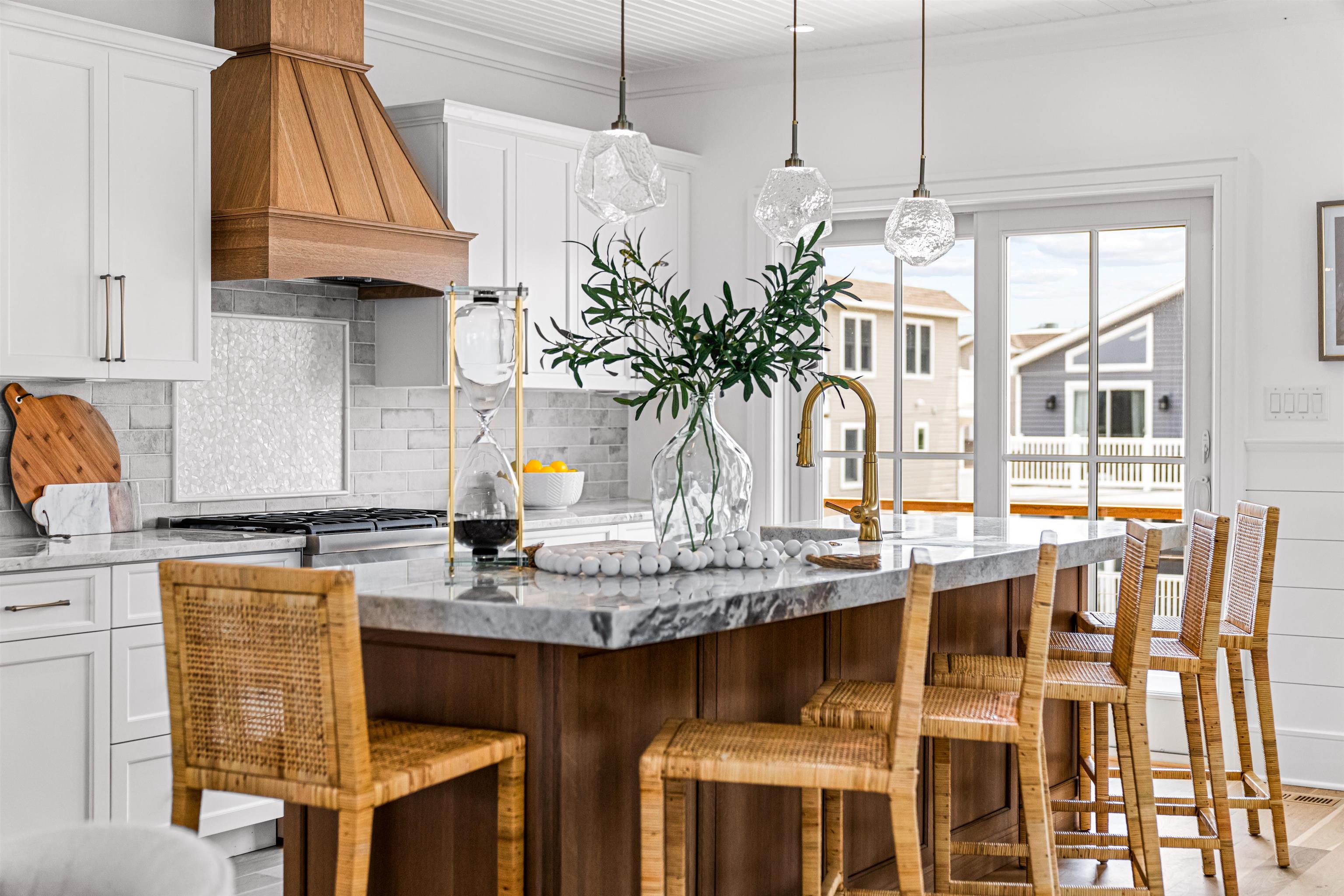 2158 Ocean Drive, Unit 2158 Avalon, NJ 08202 - Photo 22 of 50 a kitchen with stainless steel appliances granite countertop a table chairs in it and wooden floors
