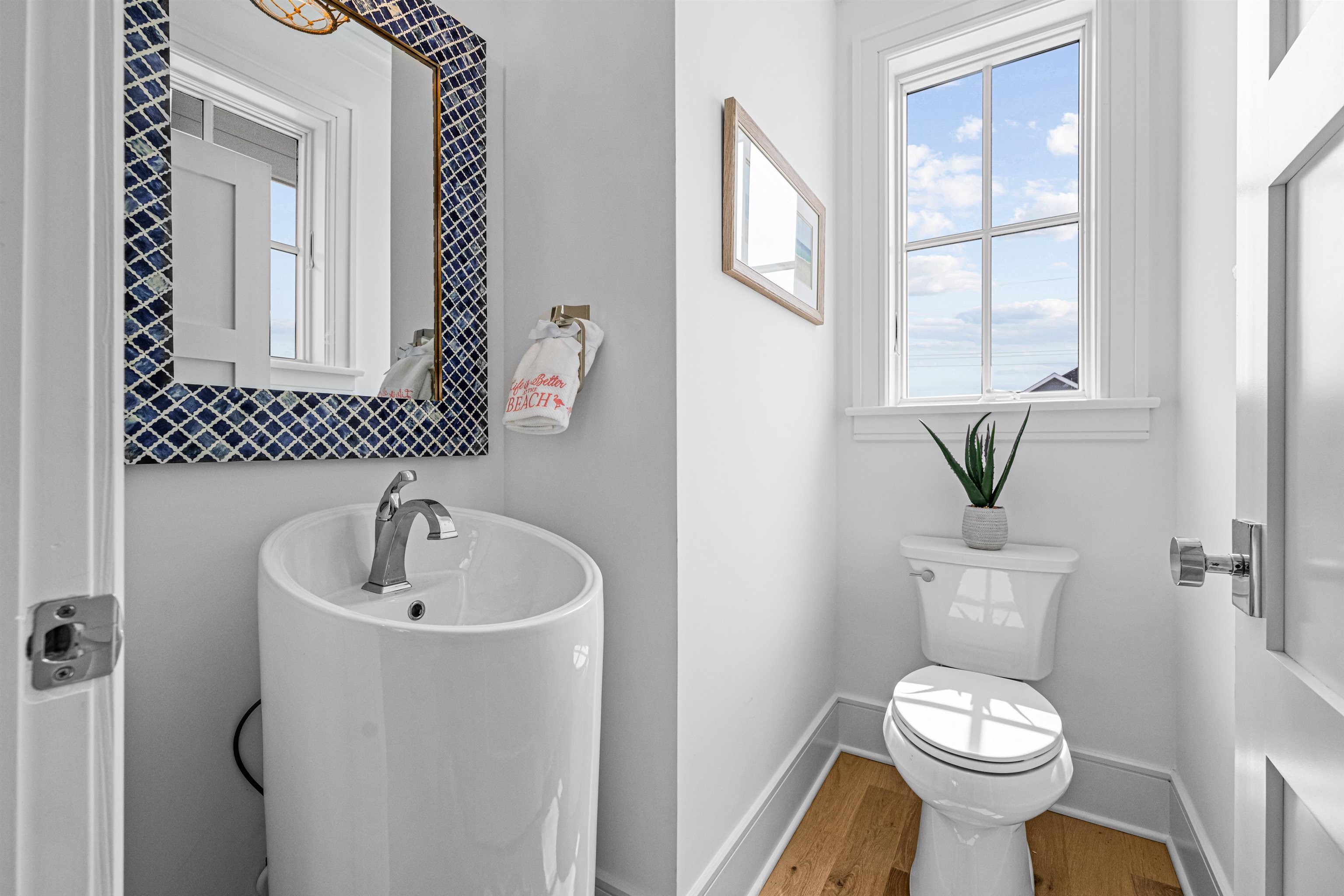 2158 Ocean Drive, Unit 2158 Avalon, NJ 08202 - Photo 34 of 50 a white toilet sitting next to a bathroom sink