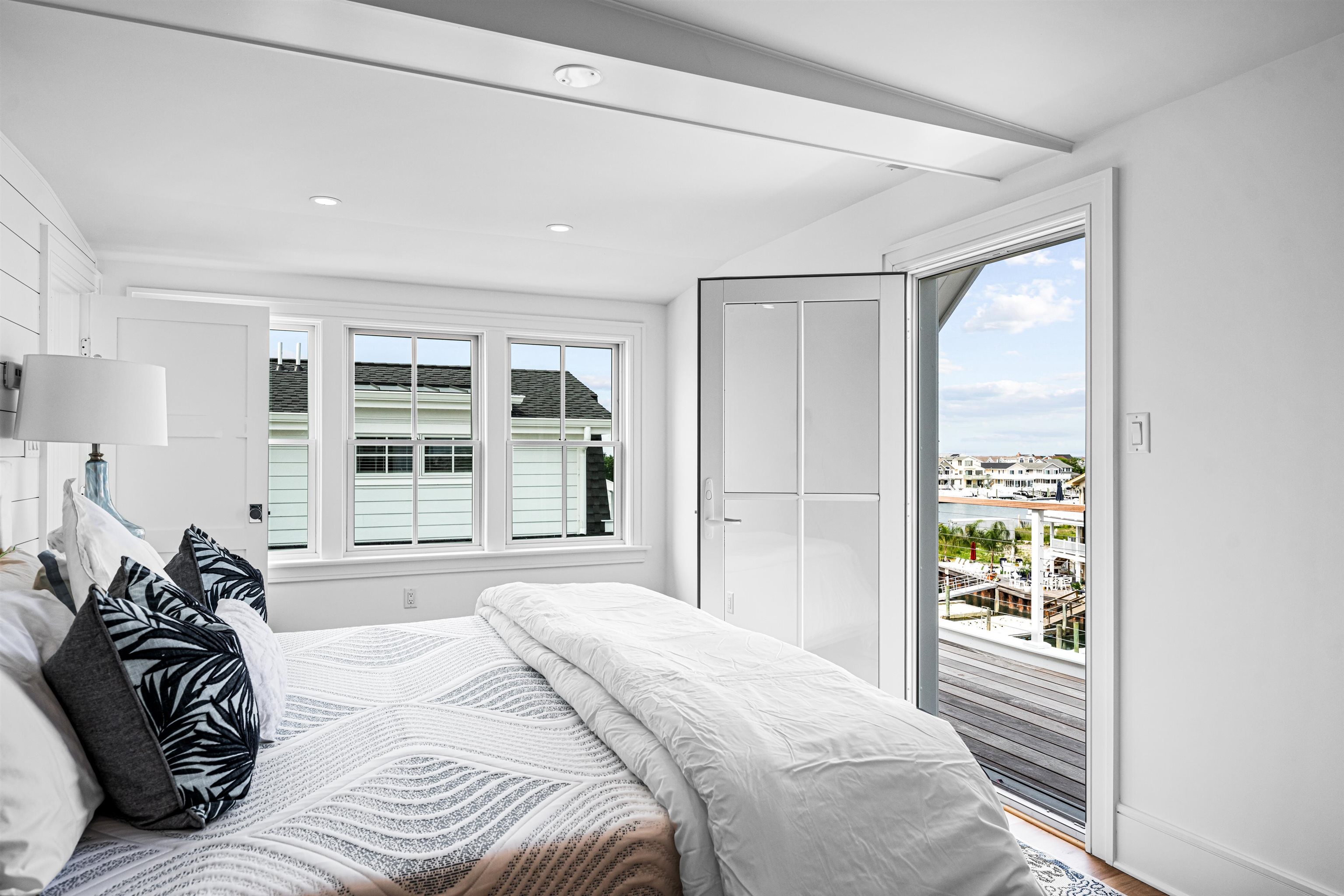 2158 Ocean Drive, Unit 2158 Avalon, NJ 08202 - Photo 36 of 50 a bedroom with a bed and a large window