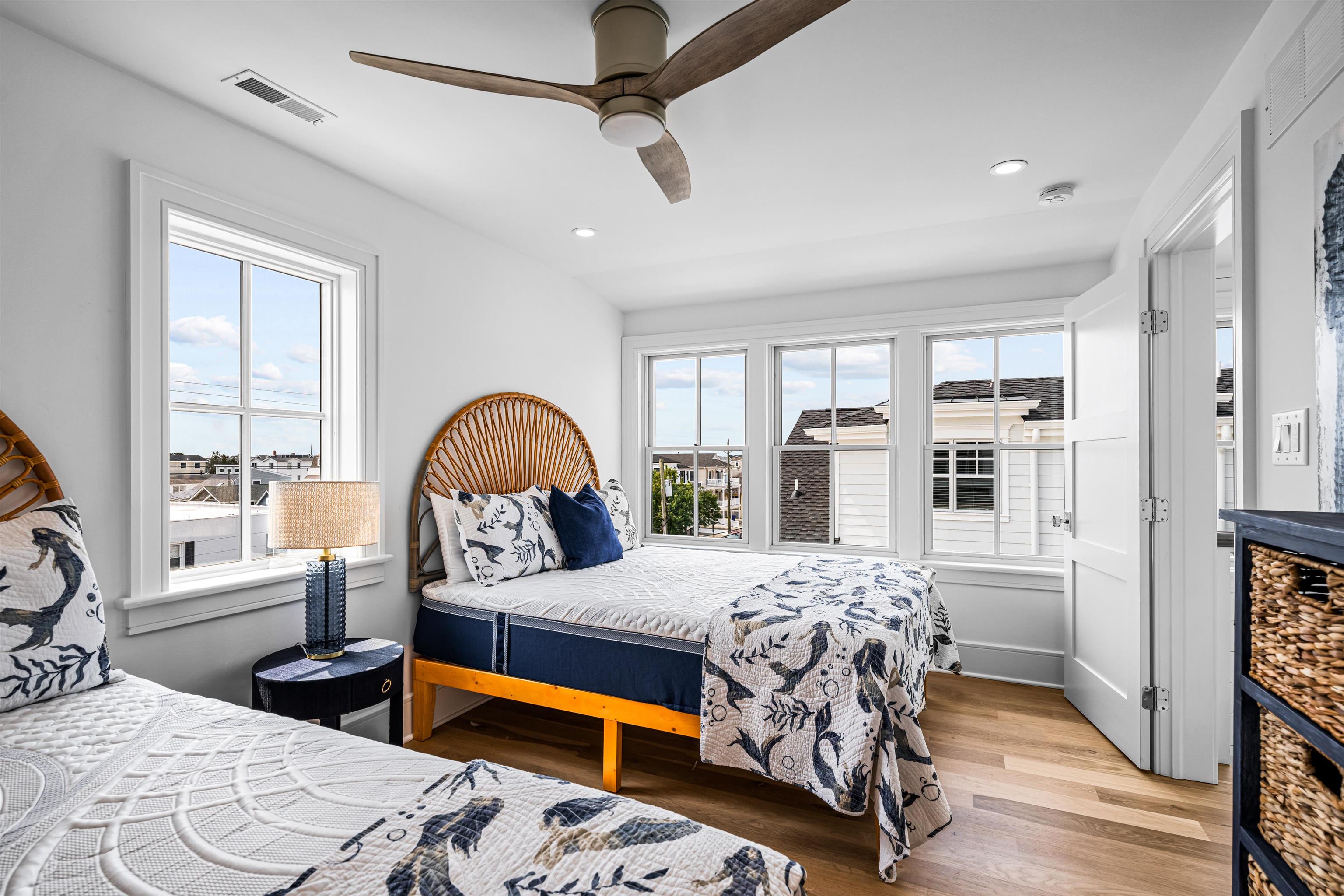 2158 Ocean Drive, Unit 2158 Avalon, NJ 08202 - Photo 41 of 50 a bedroom with a bed mirror and window