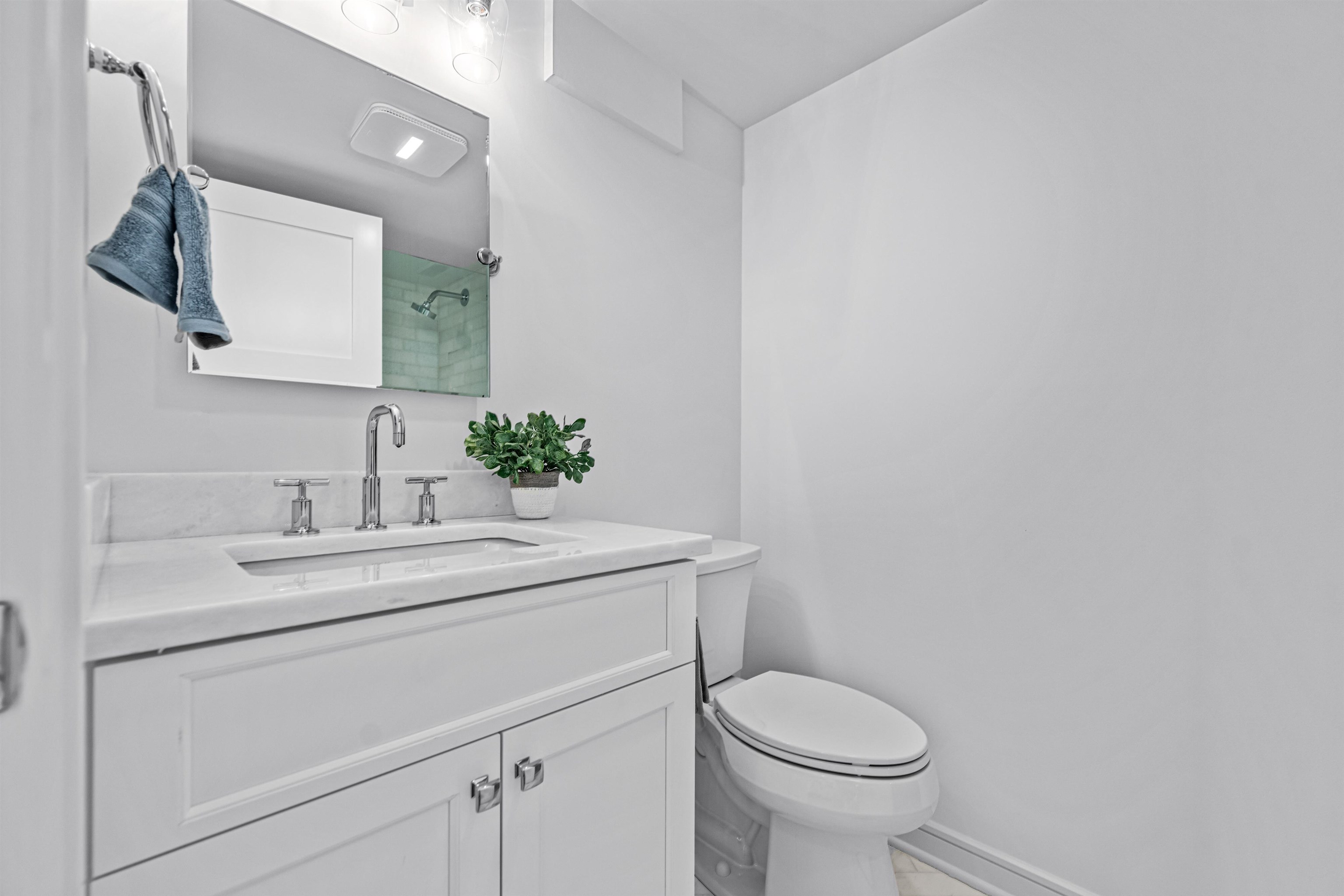 2158 Ocean Drive, Unit 2158 Avalon, NJ 08202 - Photo 42 of 50 a bathroom with a granite countertop toilet sink and mirror