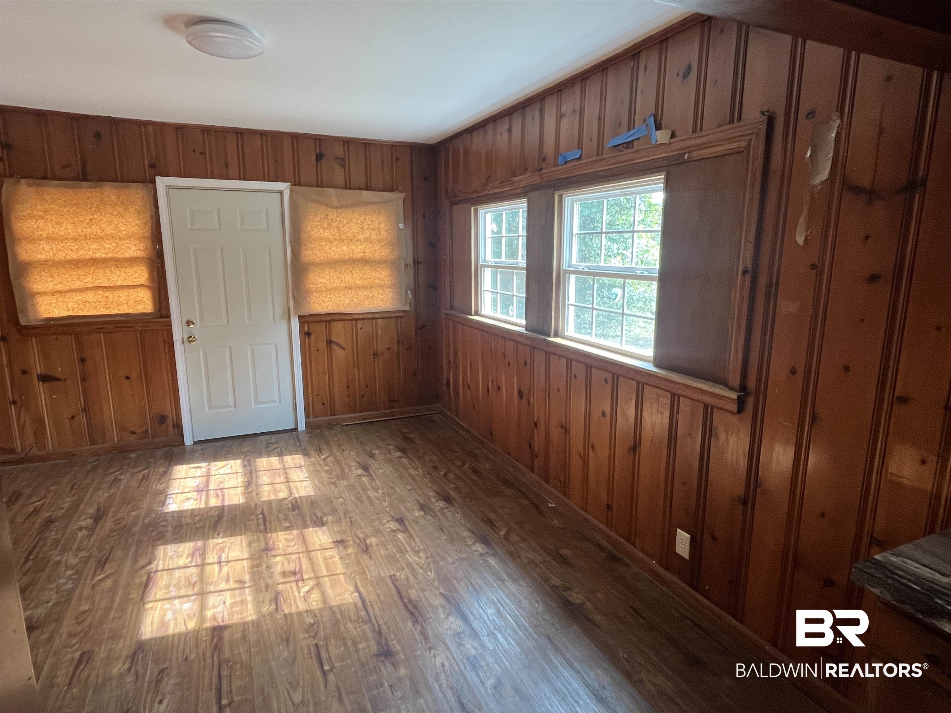5055 Overlook Road Mobile, AL 36618 - Photo 9 of 28 Unfurnished room with wooden walls and dark wood-style flooring