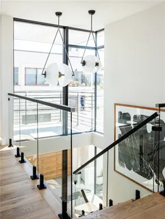 a view of a balcony with wooden floor and iron stairs