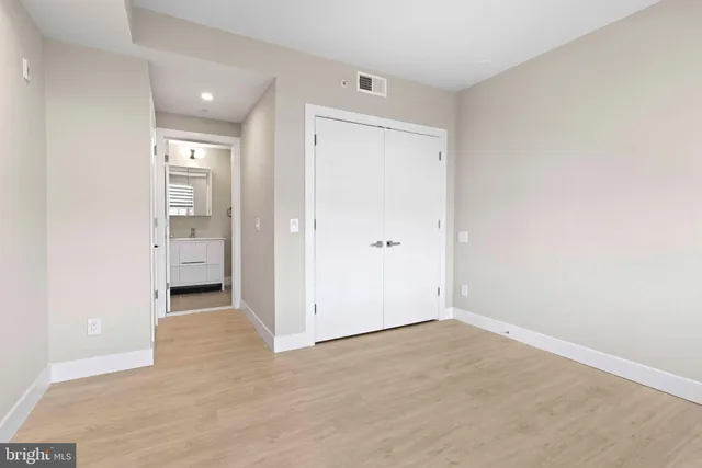 an empty room with a bathroom and a sink