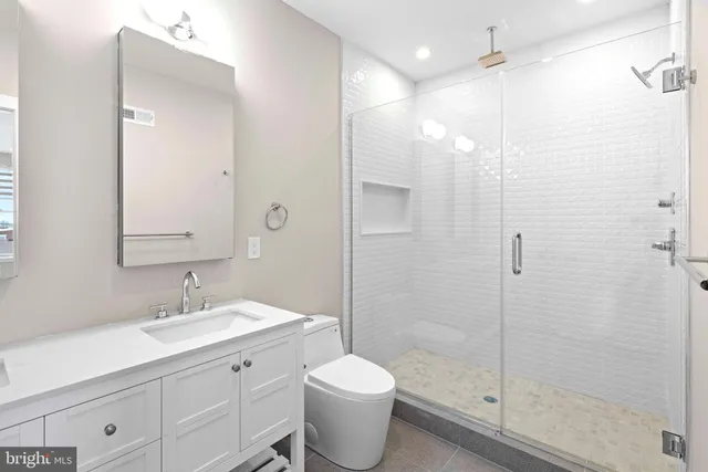 a bathroom with a sink toilet and shower