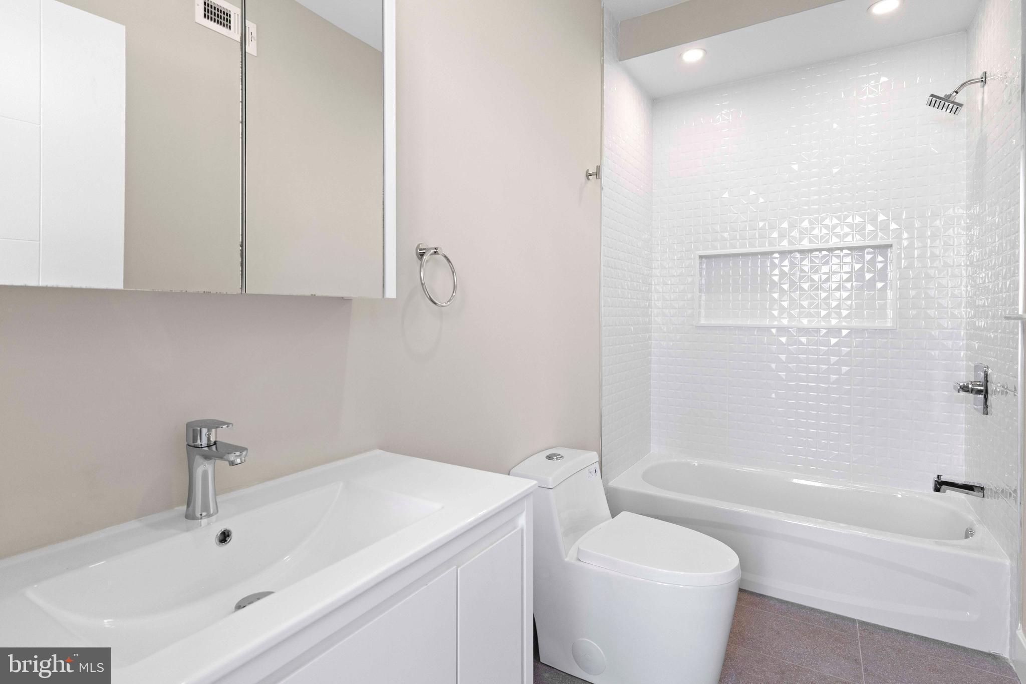 4720 Richmond Street, Unit 4 Philadelphia, PA 19137 - Photo 21 of 26 a bathroom with a sink a toilet and bathtub
