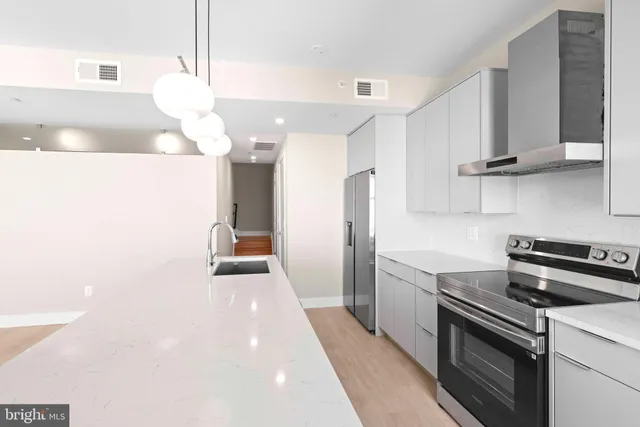 a kitchen with a sink and a stove top oven