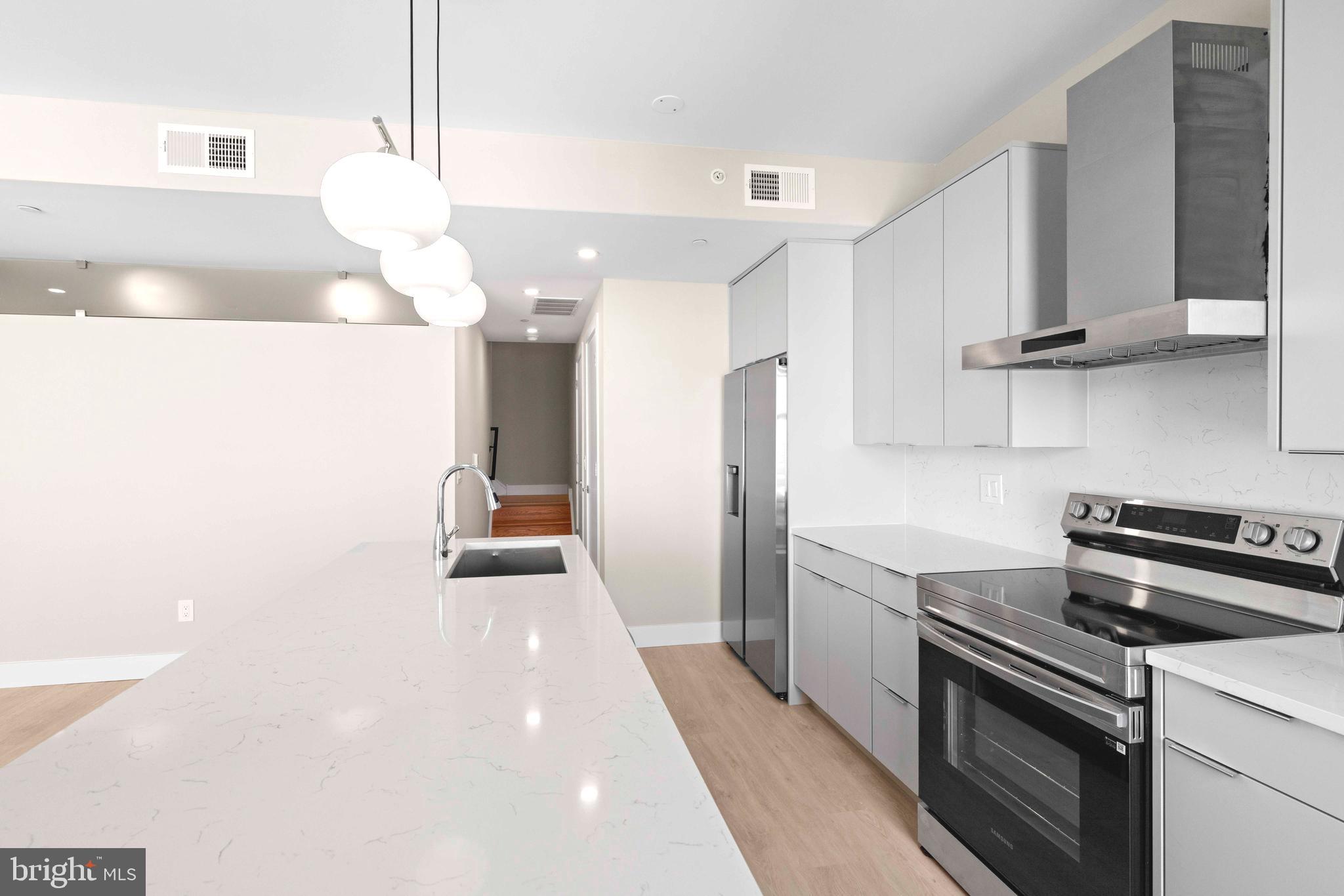 4720 Richmond Street, Unit 4 Philadelphia, PA 19137 - Photo 7 of 26 a kitchen with a sink and a stove top oven